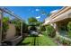 Relaxing backyard with artificial turf, a pergola, and a stone trough at 7500 E Mccormick Pkwy # 32, Scottsdale, AZ 85258