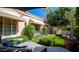 Landscaped backyard oasis with artificial turf and a built-in grill at 7500 E Mccormick Pkwy # 32, Scottsdale, AZ 85258