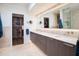 Spa-like bathroom with dual vanities, a walk-in shower and a large closet at 7500 E Mccormick Pkwy # 32, Scottsdale, AZ 85258