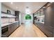 Long modern kitchen with an archway opening to a seating area at 7500 E Mccormick Pkwy # 32, Scottsdale, AZ 85258