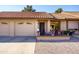 Tan brick home with tile roof, two-car garage, and inviting patio seating area at 7755 E Laguna Azul Ave # 147, Mesa, AZ 85209