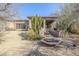 Landscaped backyard with fire pit and stairs at 8037 E Thorntree Dr, Scottsdale, AZ 85266