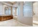Elegant bathroom with soaking tub, glass shower, and modern vanity at 8037 E Thorntree Dr, Scottsdale, AZ 85266
