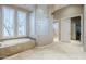 Spacious bathroom with soaking tub, glass block shower, and double sinks at 8037 E Thorntree Dr, Scottsdale, AZ 85266