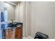 Powder room with dark vanity and vessel sink at 8037 E Thorntree Dr, Scottsdale, AZ 85266
