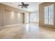 Spacious bedroom with large windows and ceiling fan at 8037 E Thorntree Dr, Scottsdale, AZ 85266
