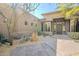 Front entry with stone accents and wooden door, surrounded by desert plants at 8037 E Thorntree Dr, Scottsdale, AZ 85266