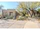 Desert landscaping surrounds this stucco home with a large driveway and three-car garage at 8037 E Thorntree Dr, Scottsdale, AZ 85266