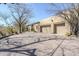 Three-car garage with large driveway, and desert landscape at 8037 E Thorntree Dr, Scottsdale, AZ 85266