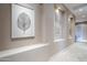 Elegant hallway with built-in niches, displaying artwork, and neutral tones at 8037 E Thorntree Dr, Scottsdale, AZ 85266