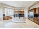 Open kitchen with large island and granite countertops at 8037 E Thorntree Dr, Scottsdale, AZ 85266