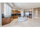 Kitchen with island, granite countertops, and wood cabinets at 8037 E Thorntree Dr, Scottsdale, AZ 85266