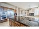 Kitchen features an island, stainless steel appliances, and a fireplace at 8037 E Thorntree Dr, Scottsdale, AZ 85266