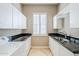Laundry room with sink and upper cabinets at 8037 E Thorntree Dr, Scottsdale, AZ 85266