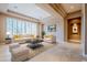 Bright living room features a comfortable sofa and chairs, coffee table, and large windows at 8037 E Thorntree Dr, Scottsdale, AZ 85266