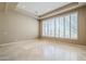 Bright and airy living room with large windows and tile floors at 8037 E Thorntree Dr, Scottsdale, AZ 85266