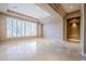 Bright and airy living room with large windows and tile flooring at 8037 E Thorntree Dr, Scottsdale, AZ 85266