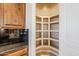 Walk-in pantry with ample shelving for storage at 8037 E Thorntree Dr, Scottsdale, AZ 85266