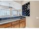 Wet bar with granite countertop, wood cabinets, and a wine rack at 8037 E Thorntree Dr, Scottsdale, AZ 85266