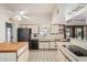 Kitchen with butcher block island, white cabinets, and tile floors at 8208 E Shea Blvd, Scottsdale, AZ 85260