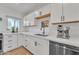 Modern kitchen with white cabinets, stainless steel appliances, and a corner sink at 827 W Weldon Ave, Phoenix, AZ 85013