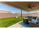 Covered patio with seating area and artificial turf at 8833 W Bloomfield Rd, Peoria, AZ 85381