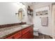 Bathroom with granite countertop, wood cabinets, and updated fixtures at 8833 W Bloomfield Rd, Peoria, AZ 85381