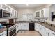 White kitchen cabinets, stainless steel appliances and granite countertops at 9331 S 33Rd Gln, Laveen, AZ 85339
