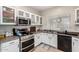 Modern kitchen with white cabinets and stainless steel appliances at 9331 S 33Rd Gln, Laveen, AZ 85339