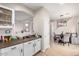 Kitchen features white cabinets, granite countertops, and a view into the dining area at 9331 S 33Rd Gln, Laveen, AZ 85339