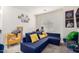 Comfortable sitting room with a blue sectional sofa and yellow accent chair at 9331 S 33Rd Gln, Laveen, AZ 85339