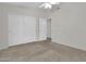 Bright bedroom with ceiling fan and double closet at 9821 E Obispo Ave, Mesa, AZ 85212