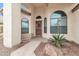 Front entry of home with arched windows and security door at 9821 E Obispo Ave, Mesa, AZ 85212