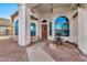 Covered entryway with arched windows and a security door at 9821 E Obispo Ave, Mesa, AZ 85212