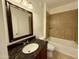 Bathroom featuring a vanity with a granite countertop, a mirror, a toilet, and a tiled shower/tub at 10136 E Southern Ave # 1110, Mesa, AZ 85209
