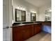 The bathroom features a dual sink vanity with granite countertops and decorative framed mirrors at 10136 E Southern Ave # 1110, Mesa, AZ 85209