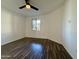 A bedroom features hard surface floors, a ceiling fan, and a window that provides natural light at 10136 E Southern Ave # 1110, Mesa, AZ 85209