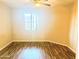 Comfortable bedroom with wood-look floors and large window at 10136 E Southern Ave # 1110, Mesa, AZ 85209