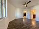 This bedroom features hard surface floors, a ceiling fan, and doorways to the kitchen and bathroom at 10136 E Southern Ave # 1110, Mesa, AZ 85209