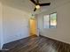 A bedroom features hard surface floors, a ceiling fan, and a window that provides natural light at 10136 E Southern Ave # 1110, Mesa, AZ 85209