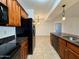 Bright kitchen features granite counters, wood cabinets, stainless steel appliances and pendant lighting at 10136 E Southern Ave # 1110, Mesa, AZ 85209