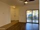 Spacious living area boasts wood-look flooring and a sliding glass door to a balcony at 10136 E Southern Ave # 1110, Mesa, AZ 85209