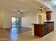 Open-concept layout with a kitchen island bar and living area with balcony access at 10136 E Southern Ave # 1110, Mesa, AZ 85209