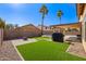 Landscaped backyard with artificial turf and fire pit at 10359 W Sunflower Pl, Avondale, AZ 85392