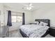 Bedroom with a queen bed, ceiling fan, and window at 10359 W Sunflower Pl, Avondale, AZ 85392