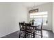 Charming dining room with dark wood table and modern light fixture at 10359 W Sunflower Pl, Avondale, AZ 85392