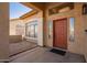 Front entry with red door and stone flooring at 10359 W Sunflower Pl, Avondale, AZ 85392