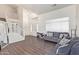 Bright living room with hardwood floors and gray couches at 10359 W Sunflower Pl, Avondale, AZ 85392