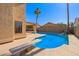 Inviting swimming pool with diving board and waterfall feature at 10359 W Sunflower Pl, Avondale, AZ 85392