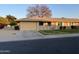 Front view of a single-story home with a garage and landscaping at 10604 W Camelot Cir, Sun City, AZ 85351